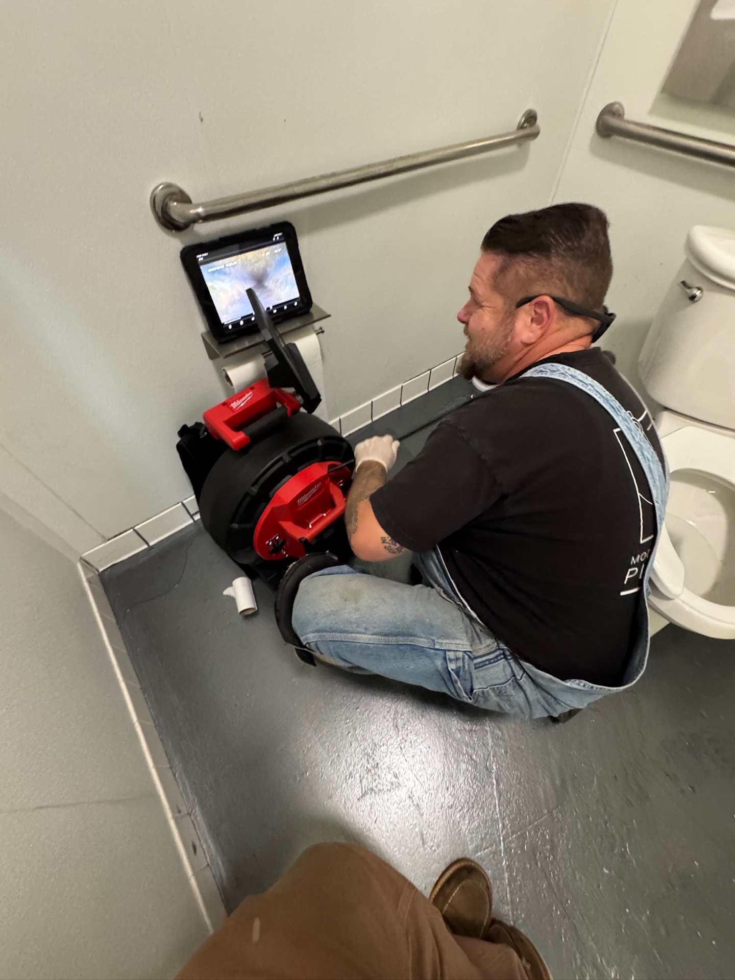 MPP technician running Milwaukee drain camera with display screen
